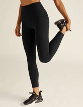 black high-waisted leggings with side pockets. midi length, stops right above ankle.
